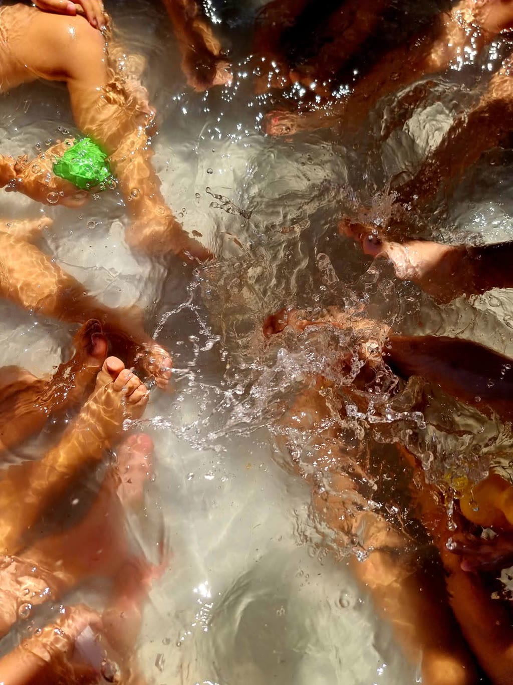 Piedi in acqua con schizzi e gocce, colori chiari e trasparenti